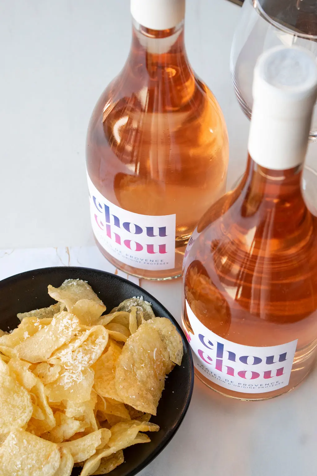 Two bottles of rosé with a bowl of crisps at Soho